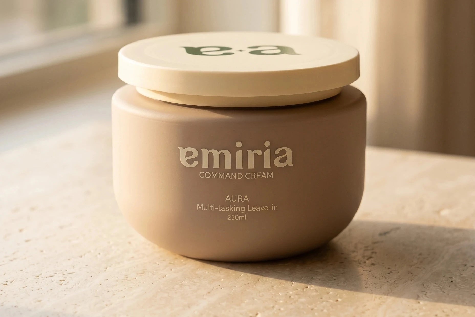 Jar of emiria Command Cream on a light surface with a blurred background