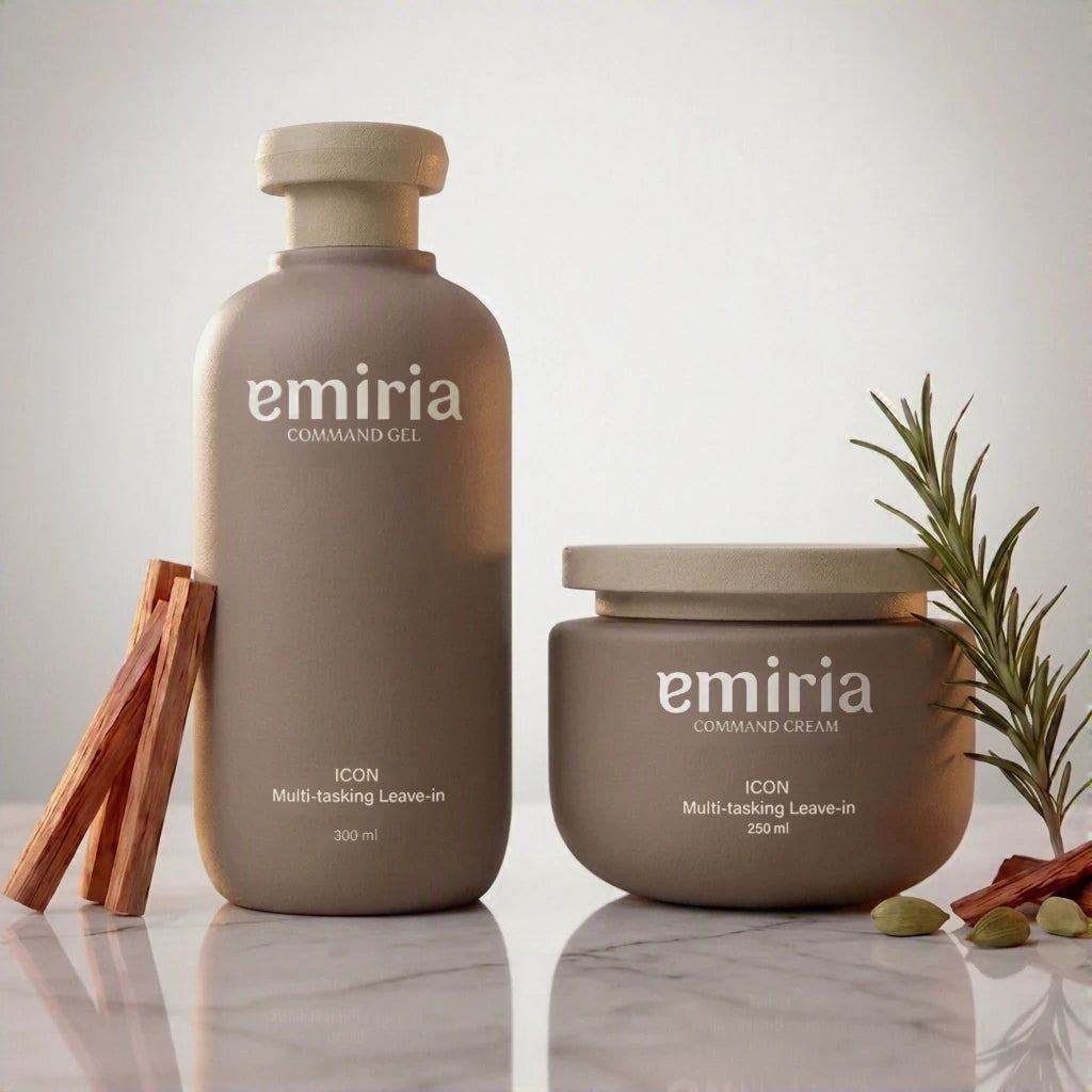 Emiria Command Gel and Command Cream haircare products in matte taupe packaging, styled on a marble surface with cinnamon sticks and rosemary sprigs.